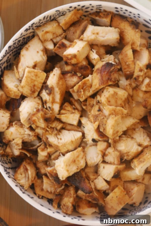Restaurant-Style Chipotle Chicken Recipe 4 A close-up shot of perfectly cooked, bite-sized Copycat Chipotle Chicken pieces in a bowl, showcasing the rich color and tender texture, ready for serving.
