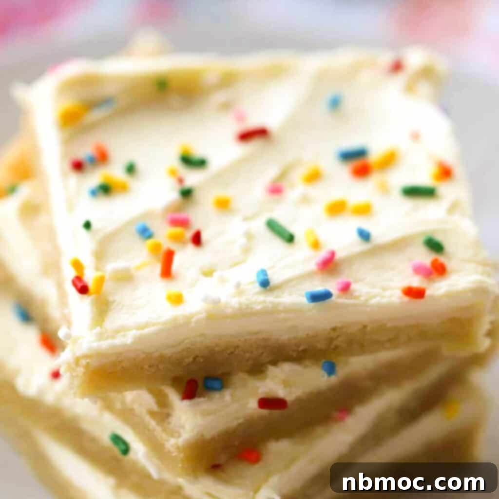 Lemon Sugar Cookie Bars topped with creamy lemon frosting and colorful sprinkles, creating an inviting dessert.