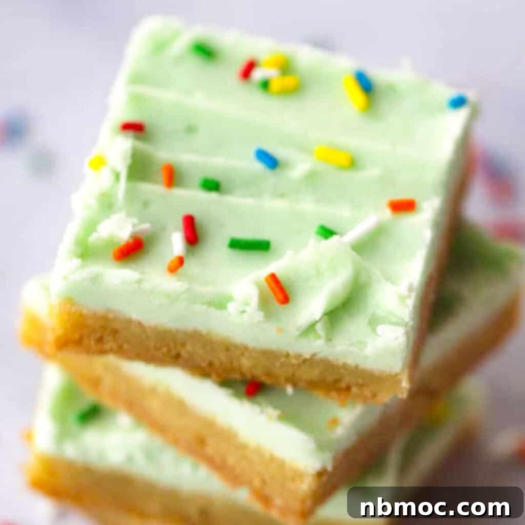 Cookie bars with vibrant lime coconut buttercream frosting, highlighting their appealing texture.