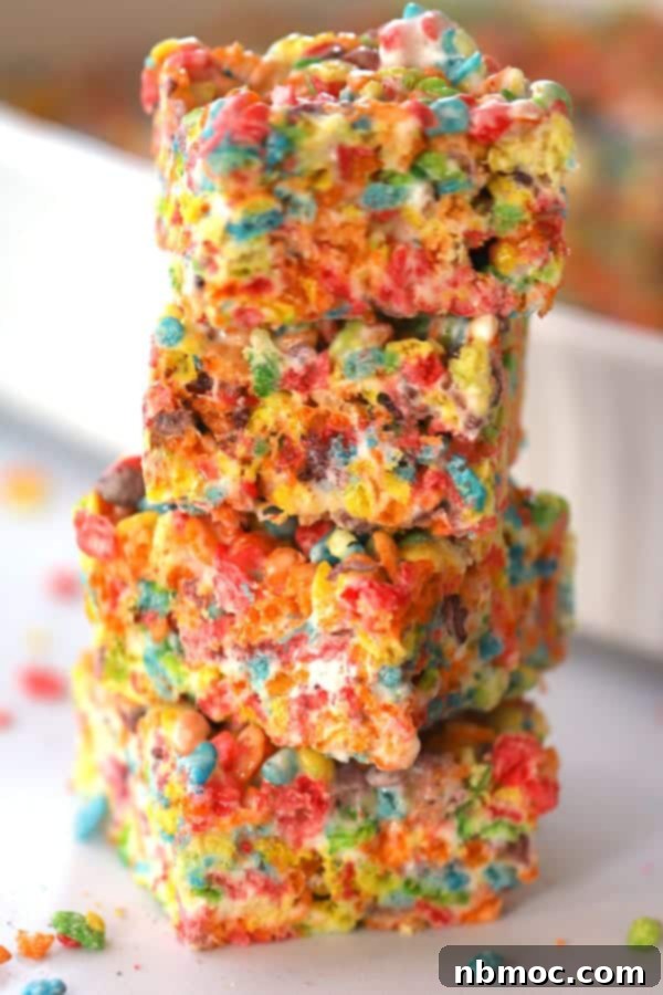 Stacked fruity pebbles rice crispy treats, showcasing their vibrant layers.