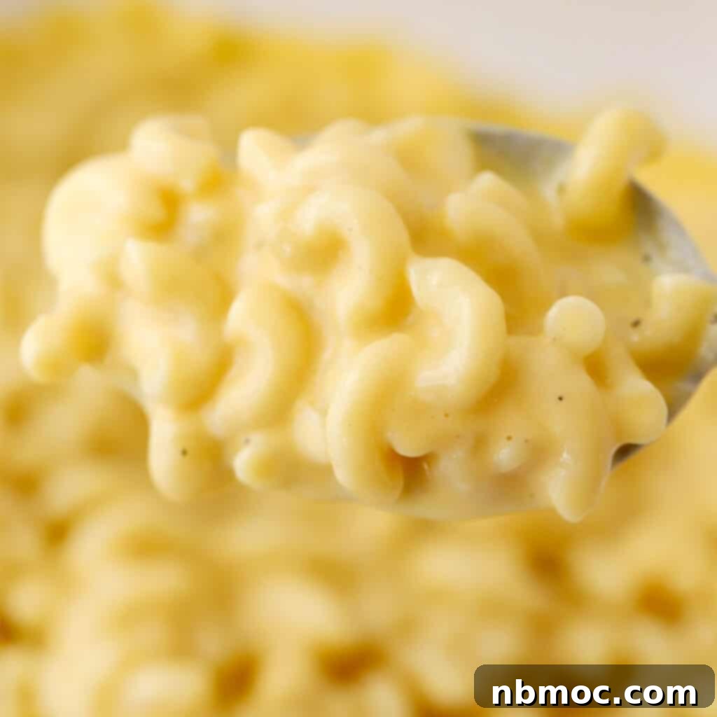 A serving of homemade mac and cheese, made creamy on the stovetop, showcased in a bowl. This easy stovetop mac and cheese is a perfect, easy Thanksgiving side dish.