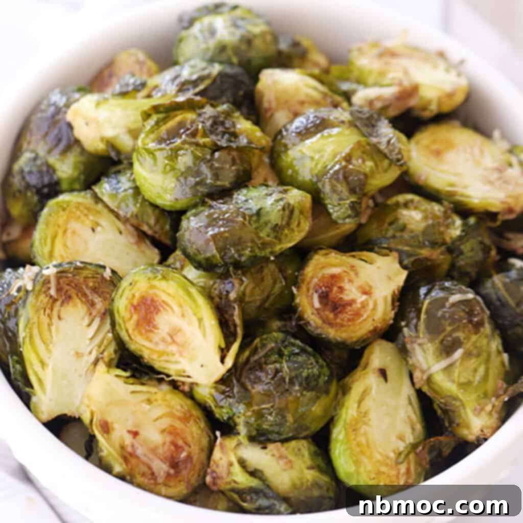 A serving dish brimming with perfectly roasted Brussels sprouts, golden and slightly charred, a prime example of the best Thanksgiving side dishes.