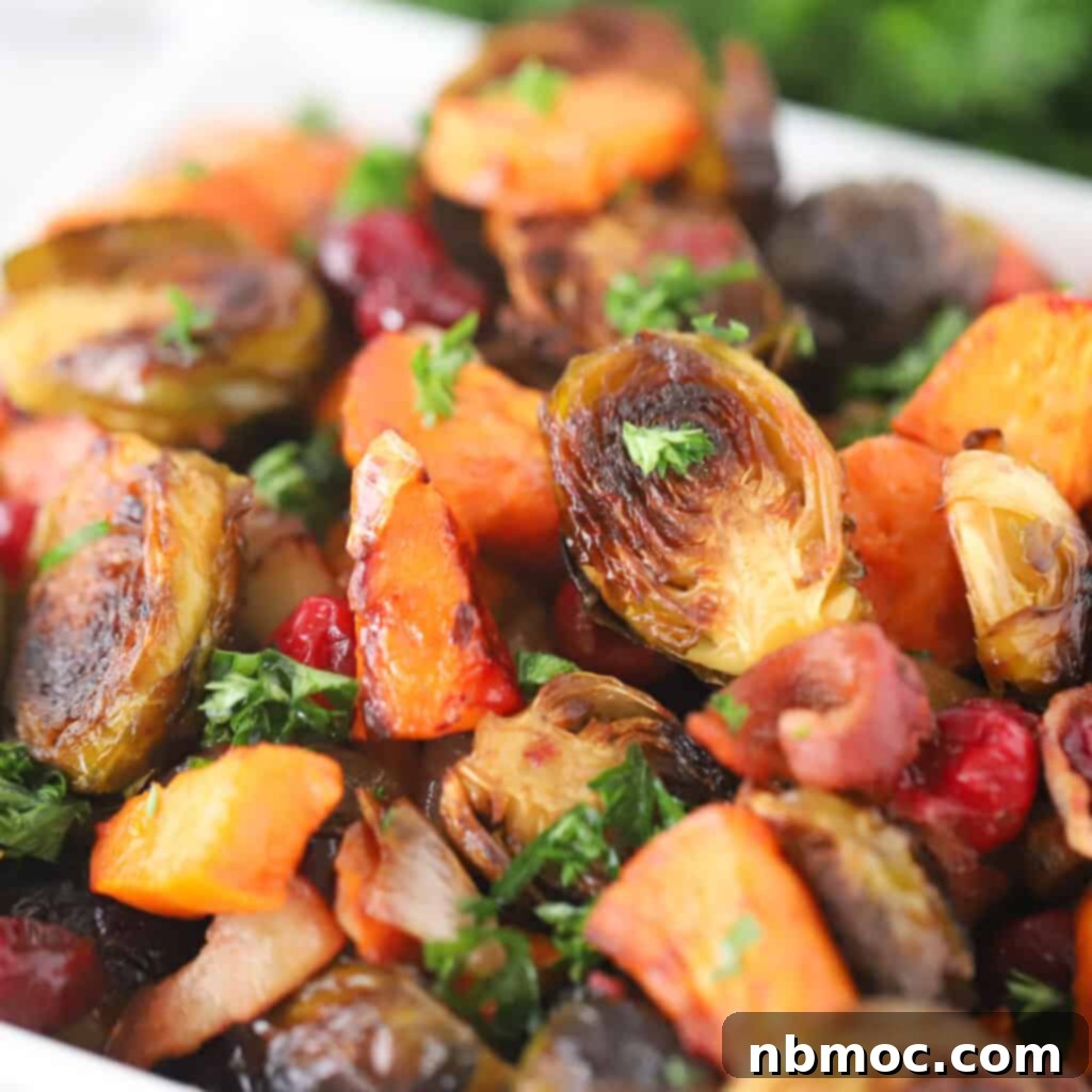 A beautiful blend of roasted Brussels sprouts and sweet potatoes, interspersed with bright red cranberries, showcasing a delightful Thanksgiving vegetable recipe.