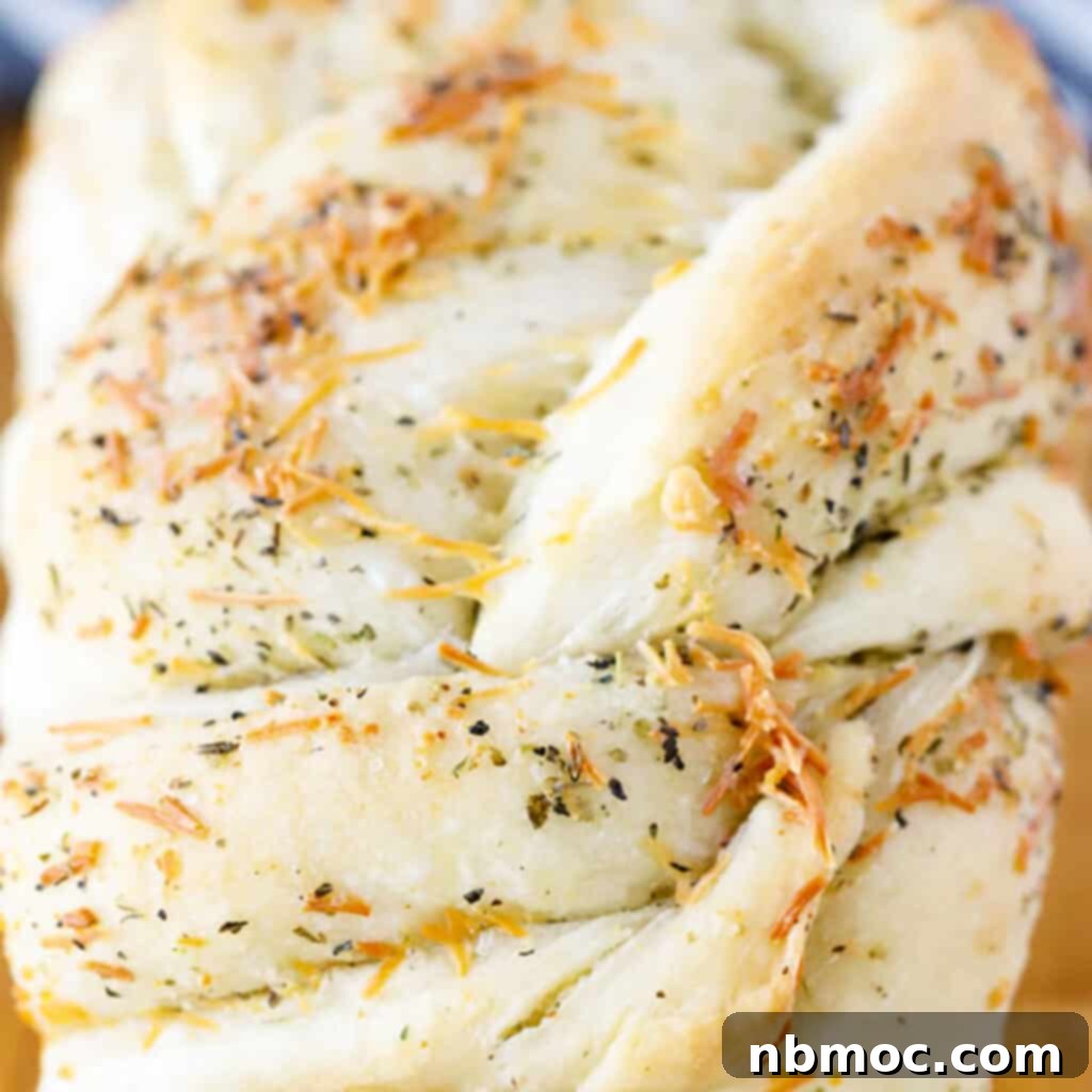 A golden-brown garlic herb twist bread, freshly baked, on a cooling rack, presenting a homemade bread recipe that is one of the best Thanksgiving side dishes.