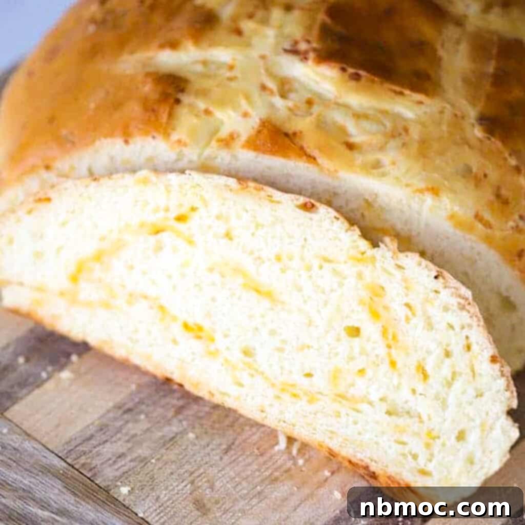 A fresh loaf of Rustic Cheddar Cheese Bread, with its golden crust and inviting texture, a wonderful holiday side dish.