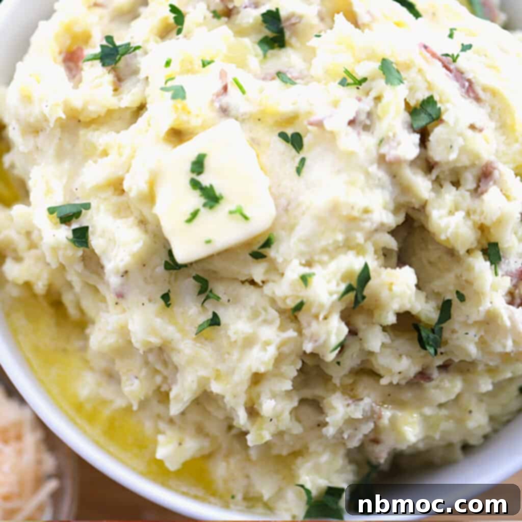 A white bowl brimming with creamy garlic mashed potatoes, ready to be served, an essential best potato side dish.