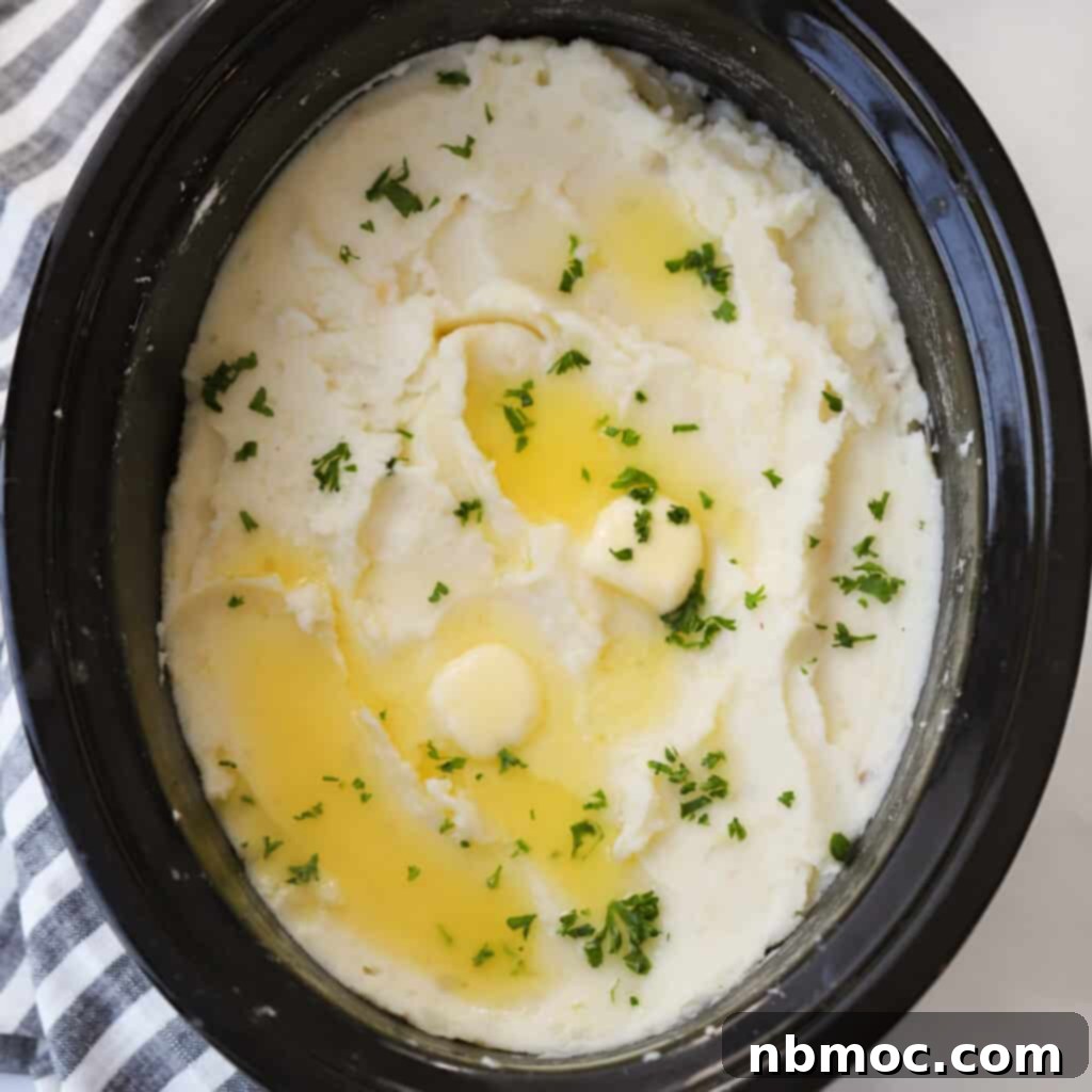 Fluffy crockpot mashed potatoes served directly from the crockpot, showcasing the ease of mashed potatoes in a slow cooker.