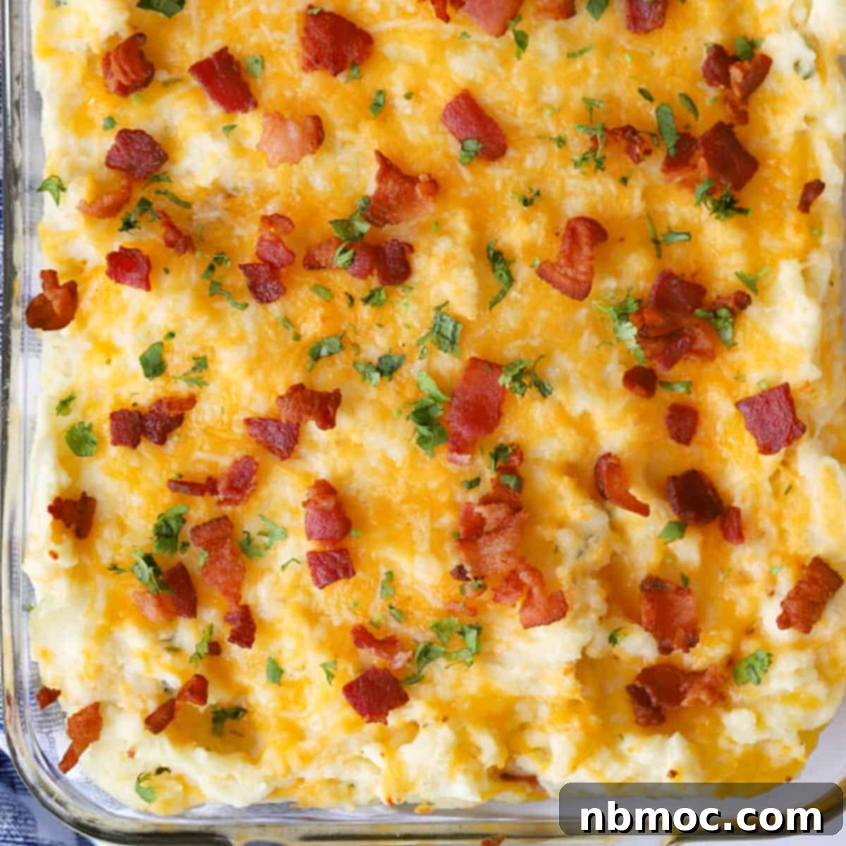 An easy make-ahead twice-baked potato casserole, bubbling with cheese and bacon, proudly presented as one of the best Thanksgiving side dishes.