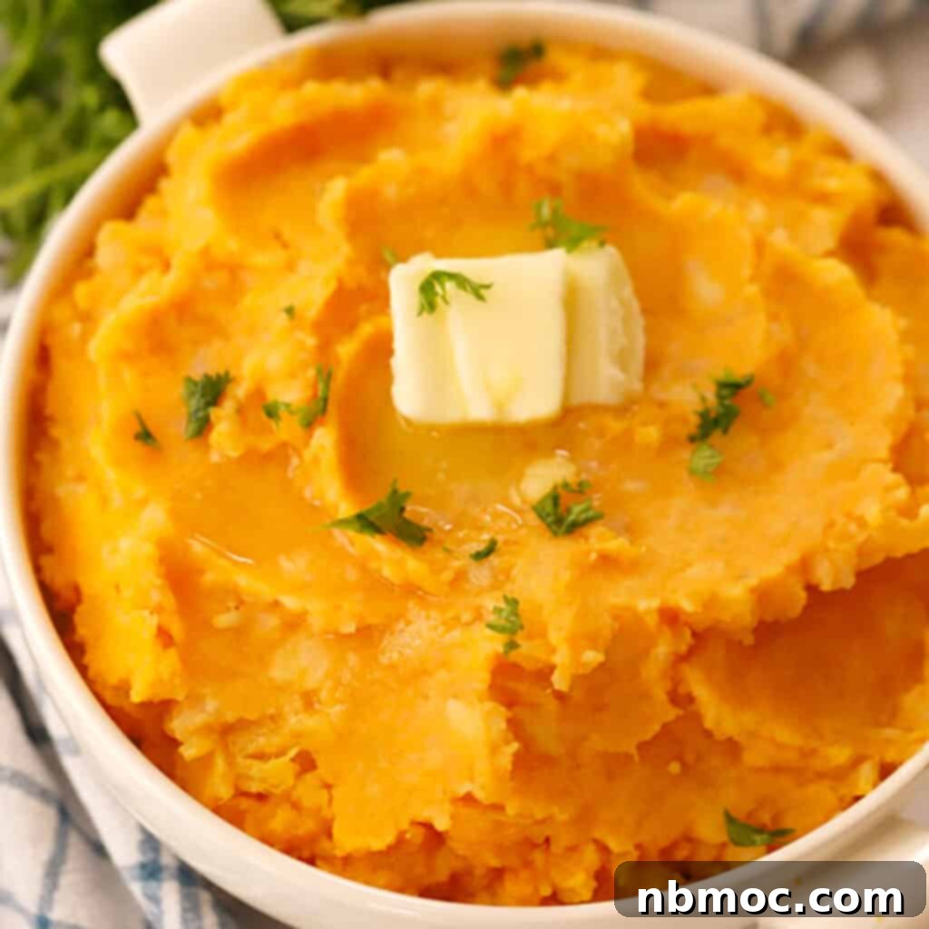 A white bowl of creamy mashed root vegetables, topped with a pat of butter, inviting and comforting.