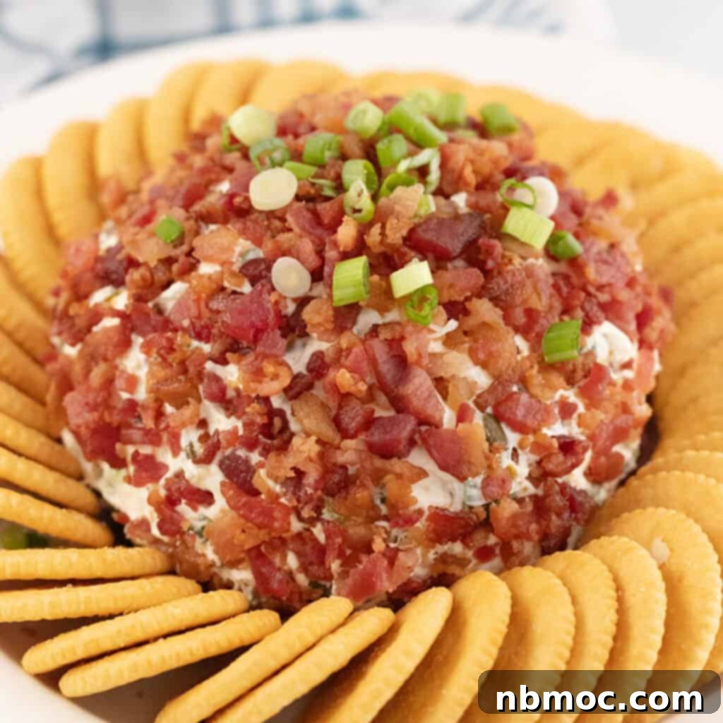 A round bacon ranch cheese ball, generously topped with sliced green onions and surrounded by a variety of crackers, ready for serving.