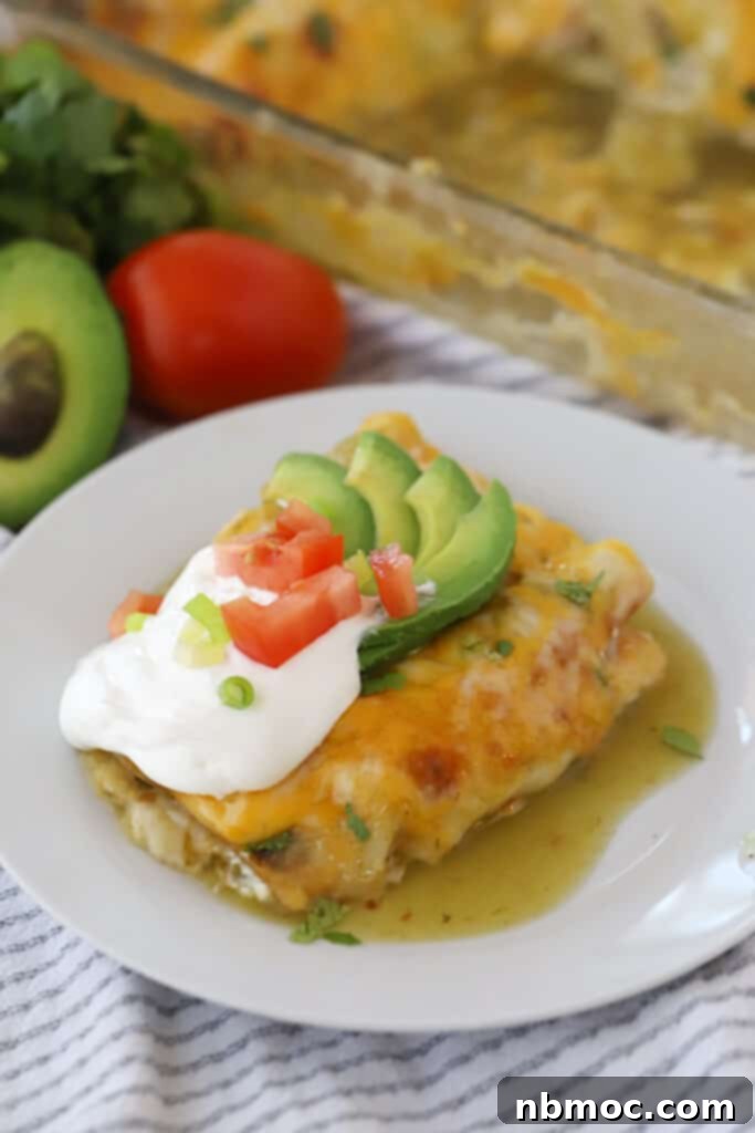 Ultimate Green Chile Chicken Enchiladas 2 Freshly baked green chicken enchiladas topped with sour cream, cilantro, and cheese