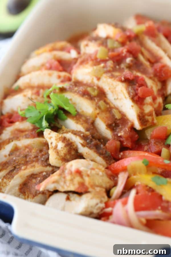 Chicken fajitas in a baking dish topped with fresh cilantro.
