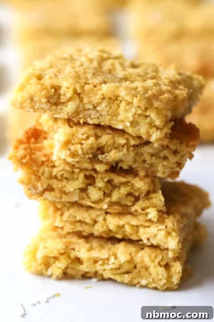 Coconut cookie bars stacked on top of each other.