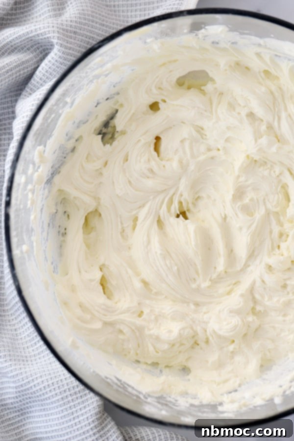 A glass bowl filled with the creamy, light cheesecake base mixture before adding the cherry topping.
