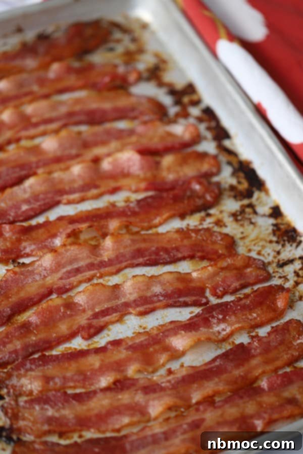 Crispy Glazed Bacon Bliss 3 Close-up of candied bacon strips on a baking sheet, showing the brown sugar coating. How to make candied bacon recipe.
