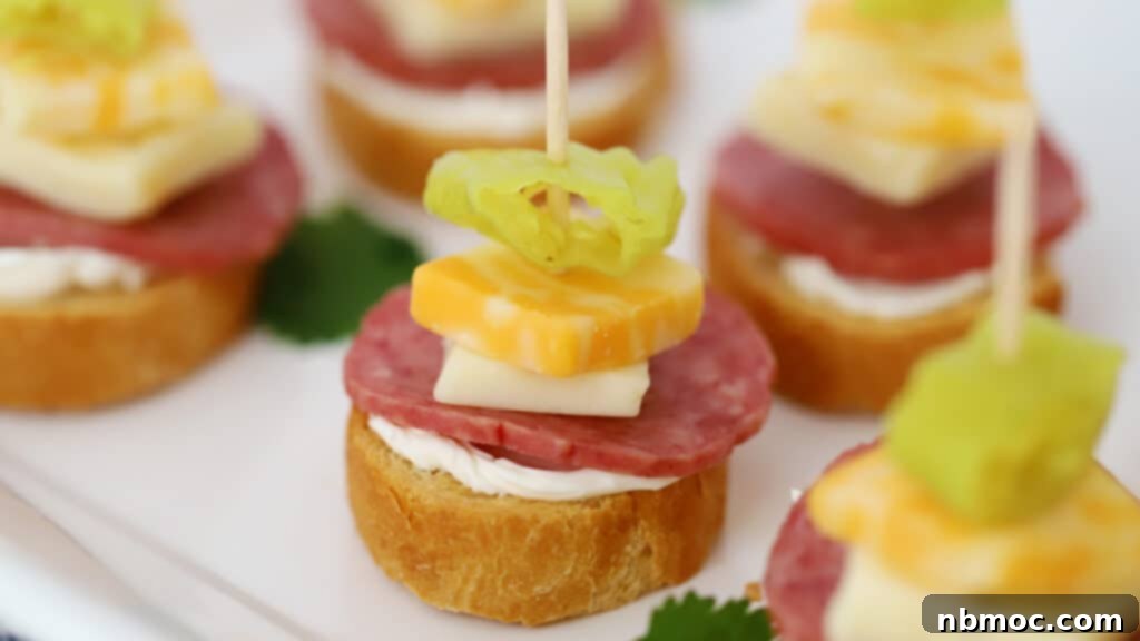 Zesty Italian Kebab Bites 3 A beautifully arranged platter showcasing Italian finger food mini appetizers with sliced baguettes, salami, and cheese.