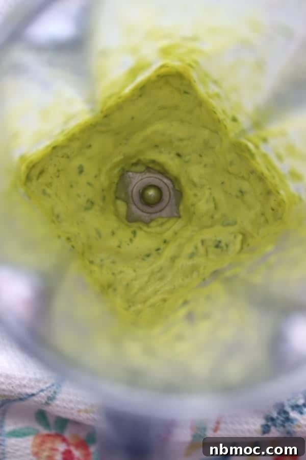 A blender with garlic basil aioli blending.