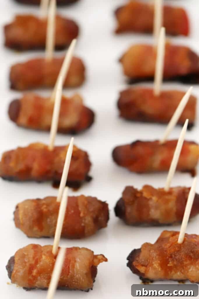 Crispy Bacon Wrapped Smokies 5 Bacon wrapped smokies with toothpicks on a baking sheet. Mini bacon wrapped hot dogs are an easy appetizer. Lil smokies b