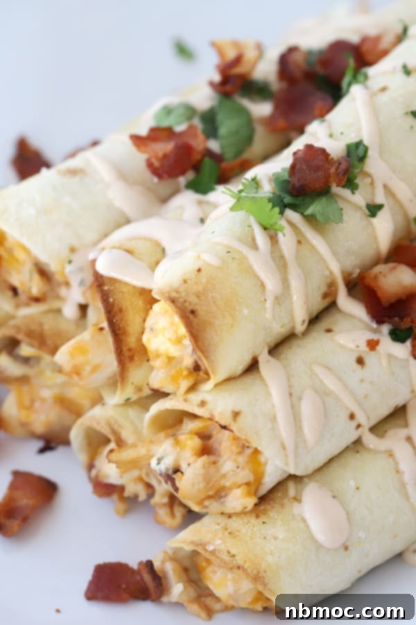 Golden Crisp BBQ Chicken Taquitos 5 Close-up of baked chicken taquitos, showcasing their golden-brown crispness and delicious filling.