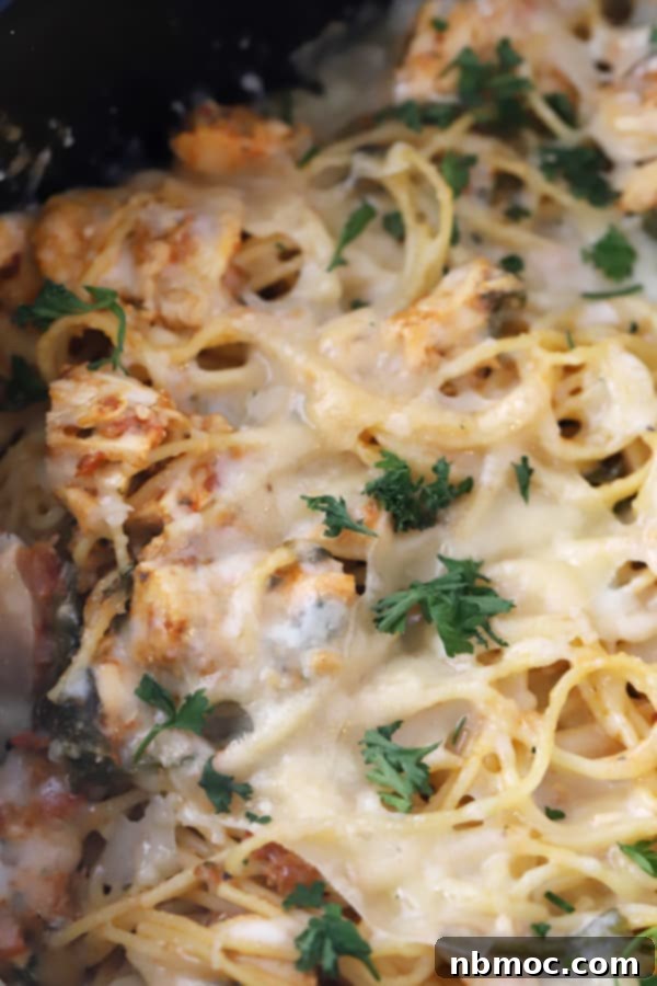 Effortless Creamy Tuscan Slow Cooker Chicken 4 crock pot Tuscan chicken pasta with mozzarella cheese and fresh parsley. crock pot tuscan chicken, chicken alfredo crockpot recipe.