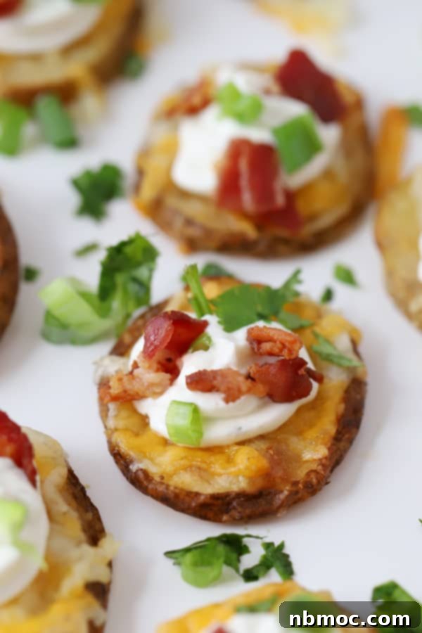 Crispy potato bites garnished with sour cream, bacon and fresh greens.