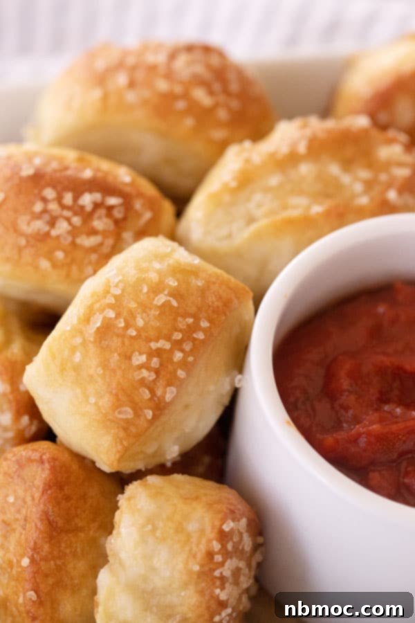 Soft pretzel bites with a side of marinara sauce.