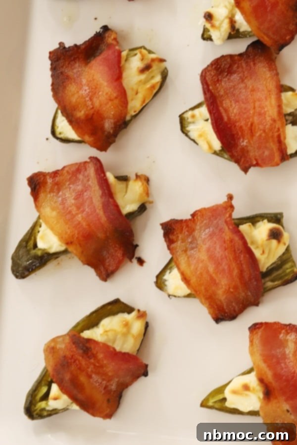 Cream cheese stuffed jalapenos topped with bacon.