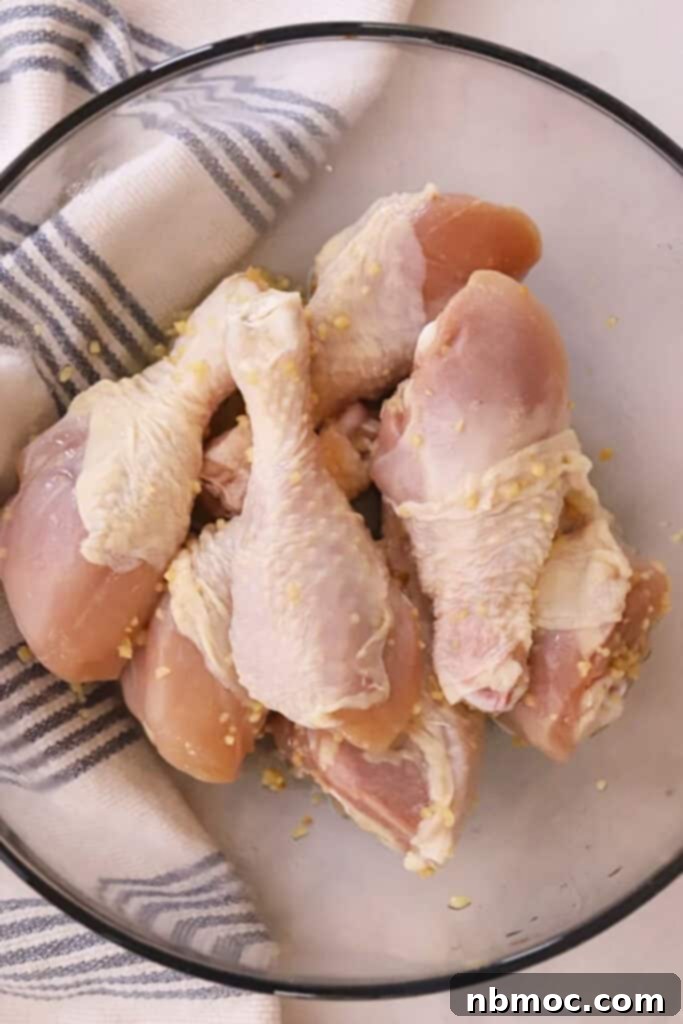 Golden Garlic Butter Drumsticks 3 Chicken drumsticks in a glass bowl with garlic butter.