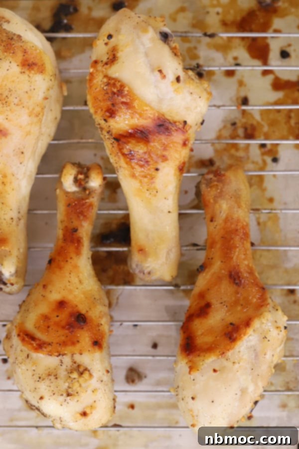 Golden Garlic Butter Drumsticks 6 Crispy baked chicken legs cooling on a wire rack.