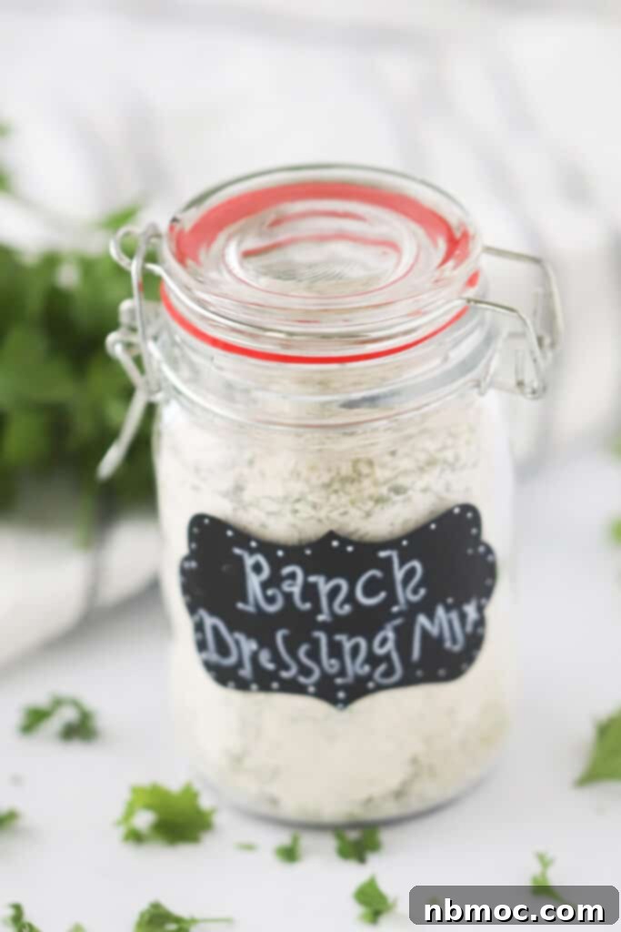 Creamy Fiesta Ranch 3 A clear glass jar with a white label reading "Ranch Dressing Mix" containing a light brown spice blend.