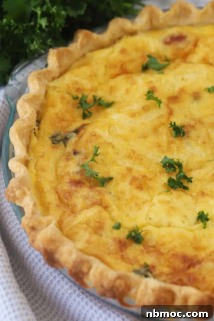 A stunning bacon and asparagus quiche recipe, perfectly baked with a golden, flaky crust, ready to be served.