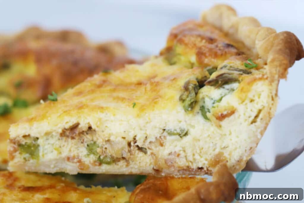 A whole asparagus quiche with bacon in a pie plate, freshly baked and ready for slicing, emphasizing delicious quiche recipes with asparagus.