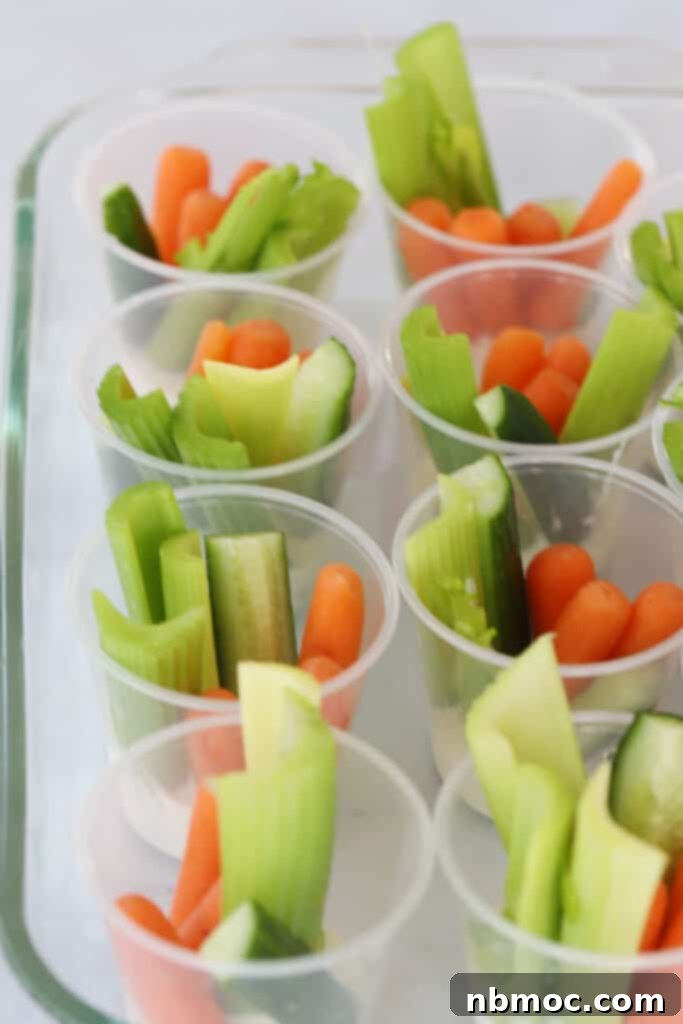 veggies and ranch in small cups with ranch dressing.