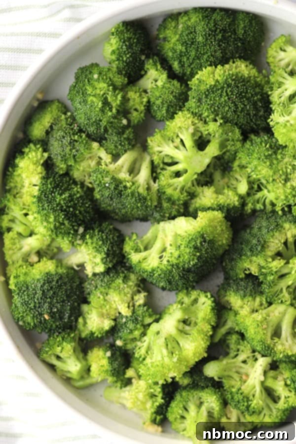 Crispy Garlic Lemon Broccoli 2 A serving dish filled with perfectly roasted garlic and lemon broccoli, showcasing its golden-brown edges and vibrant green color, ready to be served.