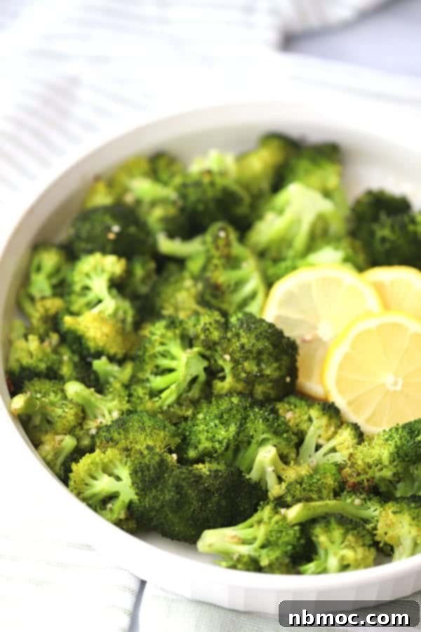Crispy Garlic Lemon Broccoli 4 A close-up of a single roasted broccoli floret with garlic and lemon, showing its crispy edges and tender interior.