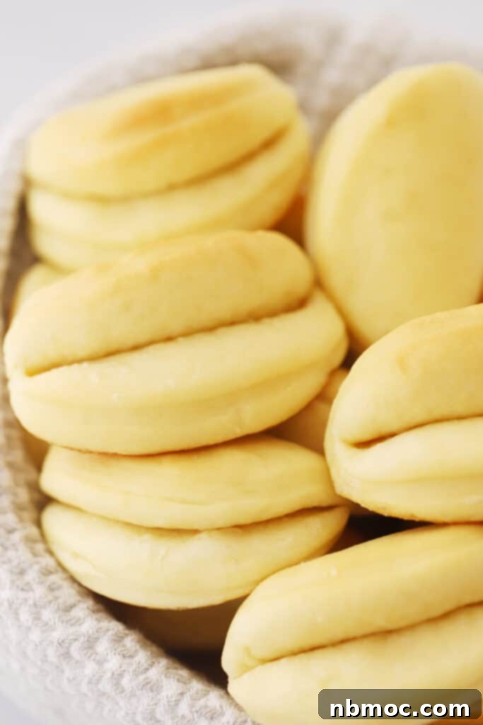 Buttery Soft Parker House Rolls 2 The best parker house rolls recipe, these parker house rolls are on a gray and white towel in a bowl