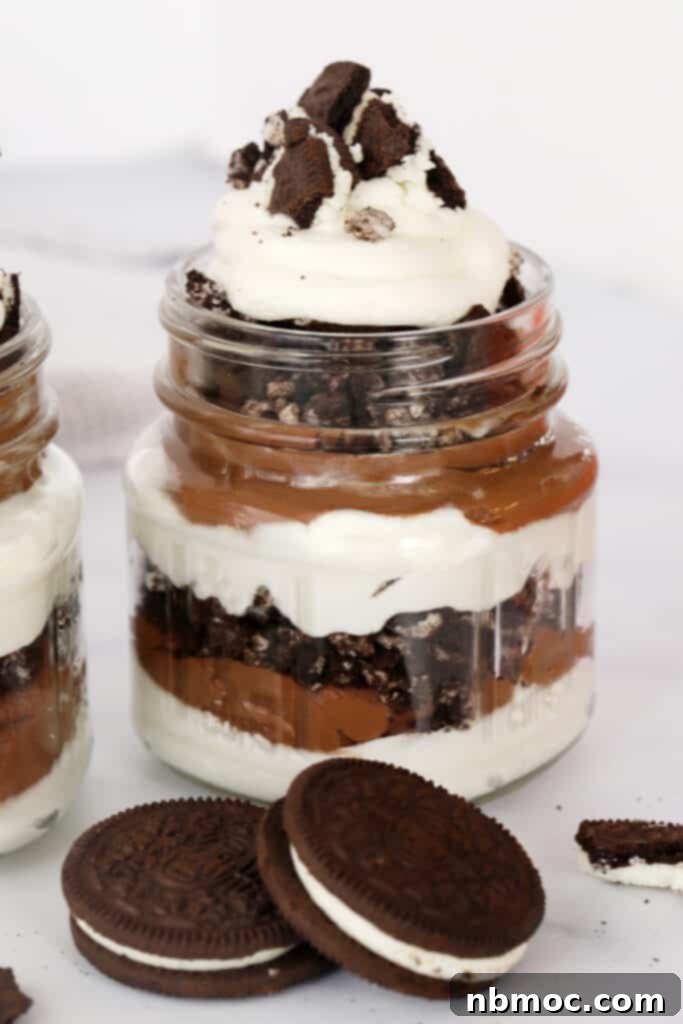 Oreo chocolate parfait layered with whipped cream, rich chocolate mousse, and caramel drizzle