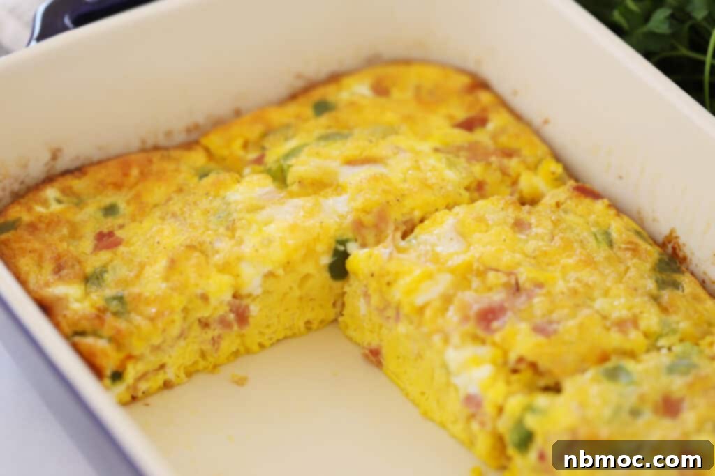 Simple Denver Omelet Breakfast Bake 5 Close-up of a baked egg casserole, showing a slice of baked Denver omelet.