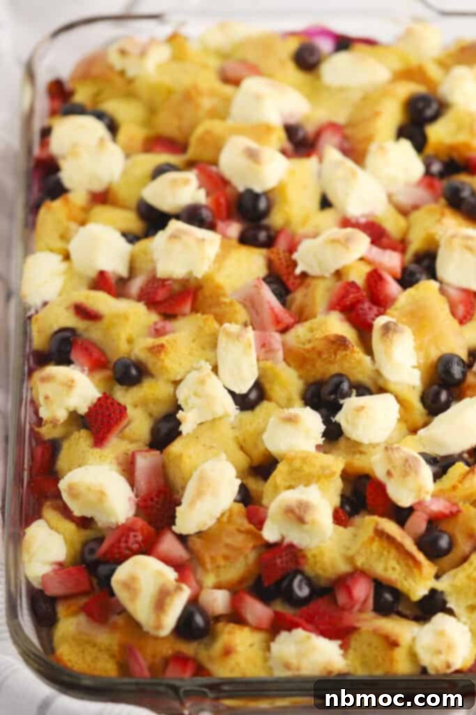 Patriotic French Toast Bake 2 4th of July blueberry stuffed French toast casserole in a baking dish, ready to be served.