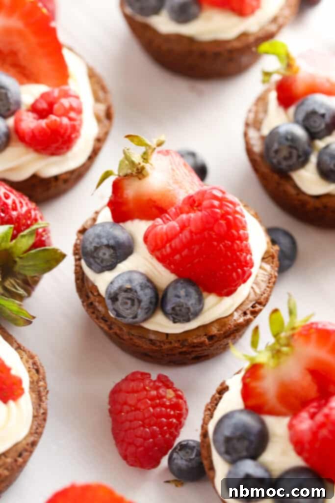 Chocolate Fudge Poppers 2 Homemade brownie cheesecake bites topped with fresh fruit, perfect for parties.