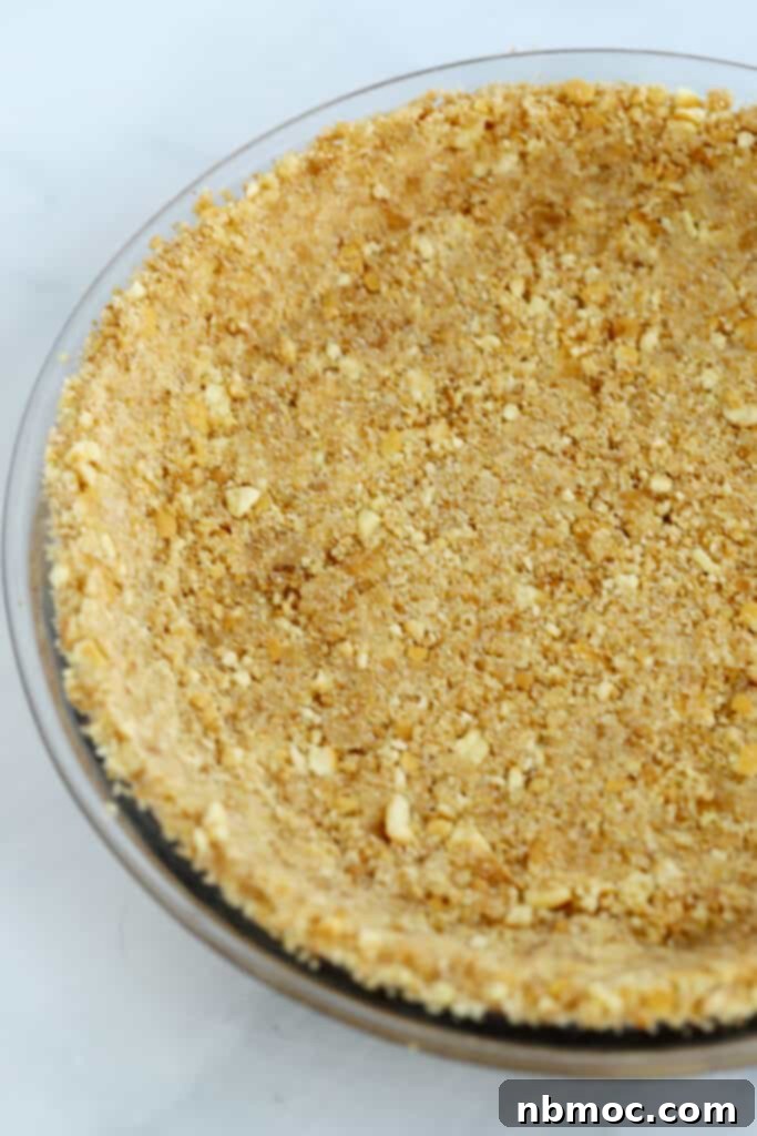 Dreamy Nilla Wafer Pie Crust 2 A pie plate with a nilla wafer pie crust pressed into it.