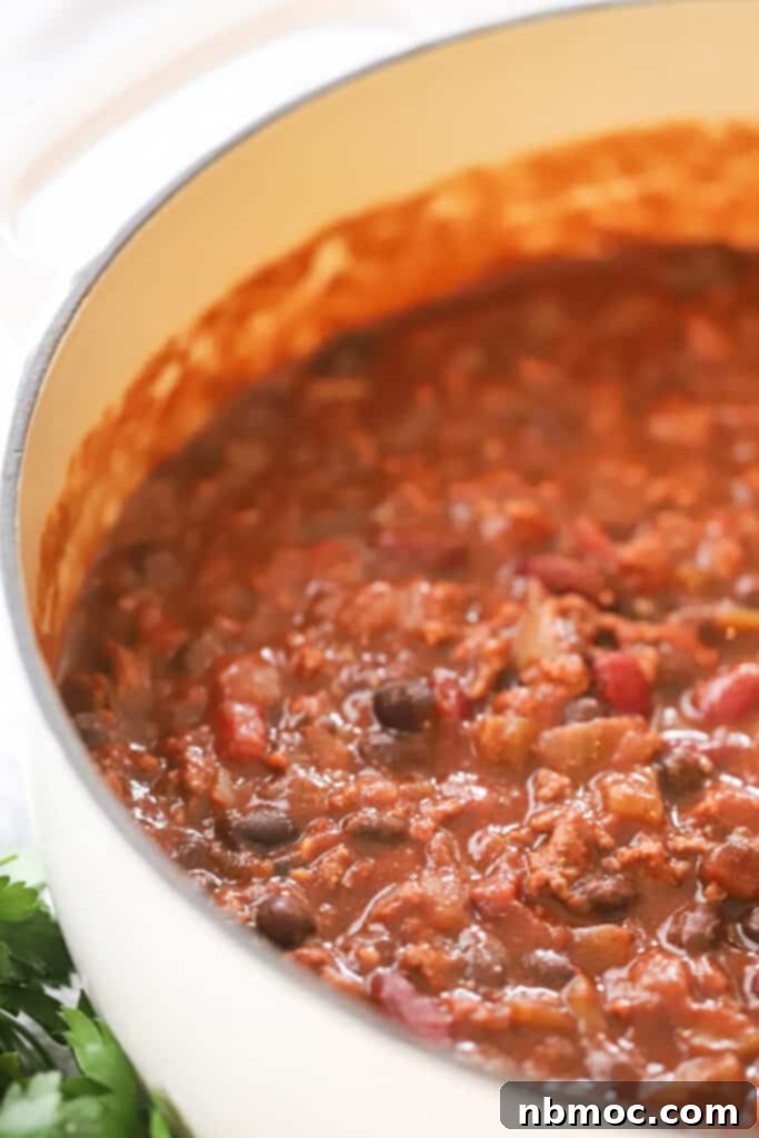 Ultimate Beef Chili 3 A large pot of rich beef chili with canned beans and ground beef, simmering to perfection.
