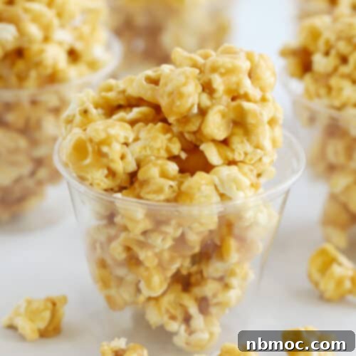 Caramel popcorn inside plastic cups on a table.
