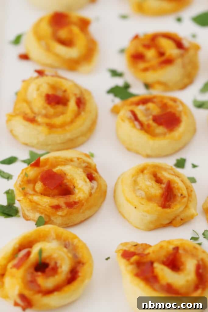A tray with pizza pinwheels all lined up.