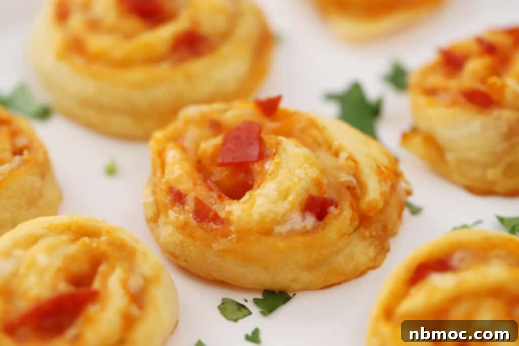 pepperoni pizza pinwheels on a white tray.