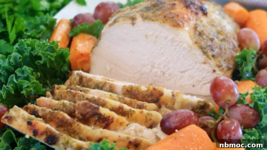 Herb Crusted Turkey breast sliced and on a white platter