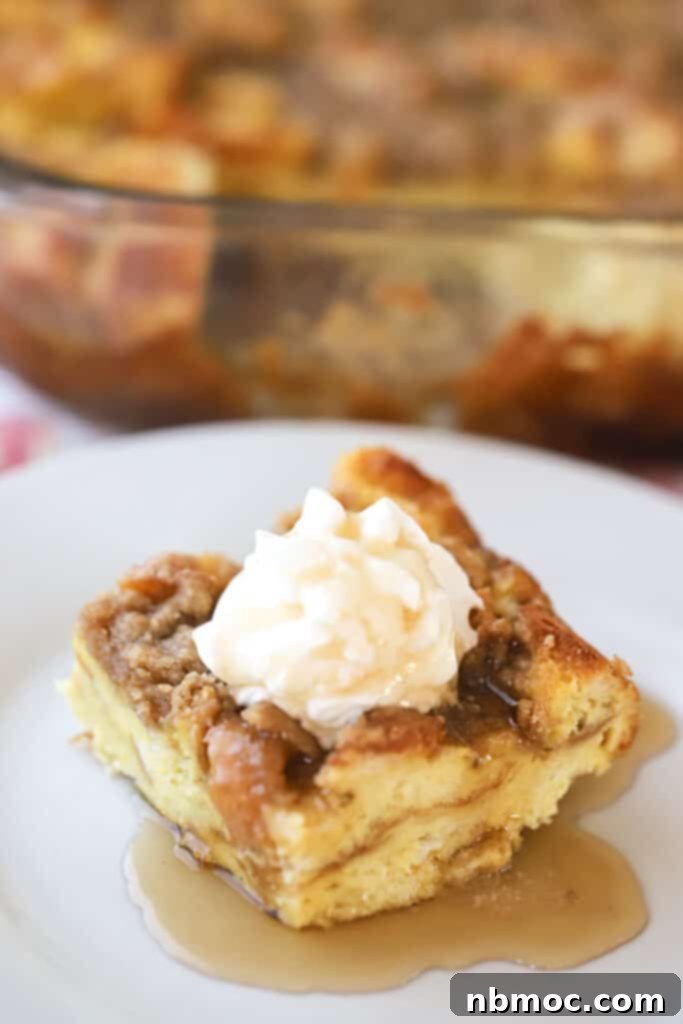 Easy french toast bake with French bread, topped with streusel and whipped cream.