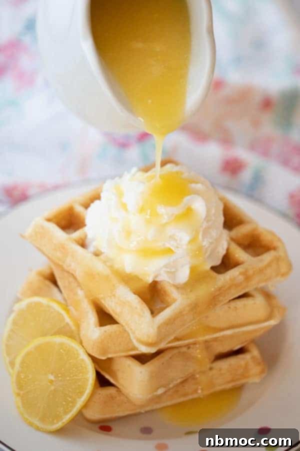 Zesty Lemon Syrup 2 A plate with waffles and lemon syrup being poured over the top, showcasing the syrup's delightful texture.