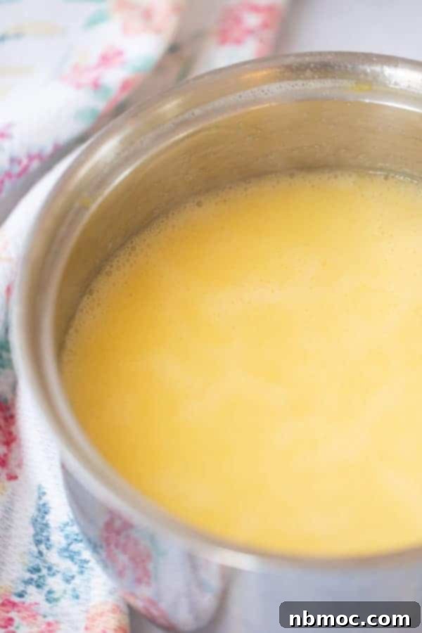 Zesty Lemon Syrup 3 A bowl with the fresh ingredients to make this lemon syrup, including vibrant lemons and egg yolks.