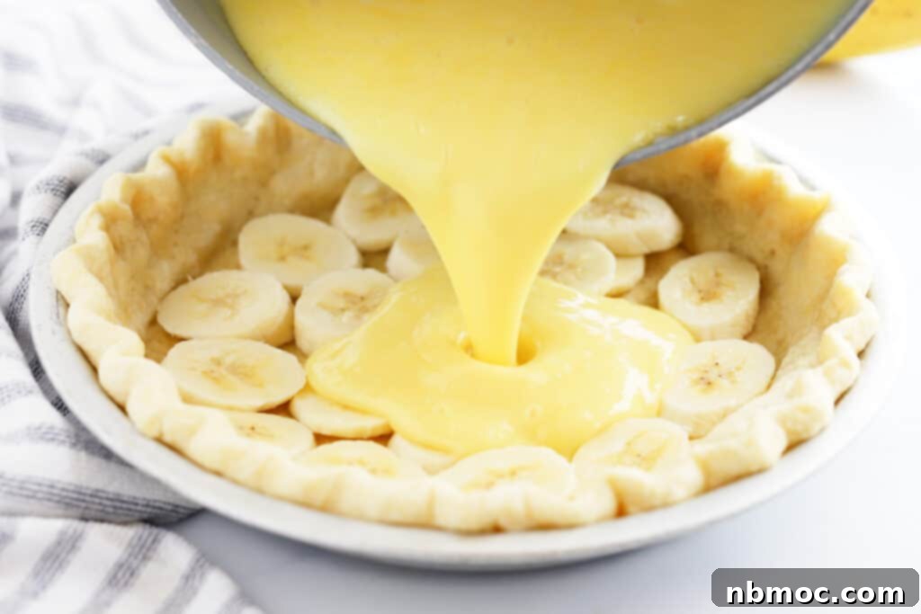 pouring the best banana cream filling Recipe into a prepared pie crust, best banana cream pie recipe, banana tart.